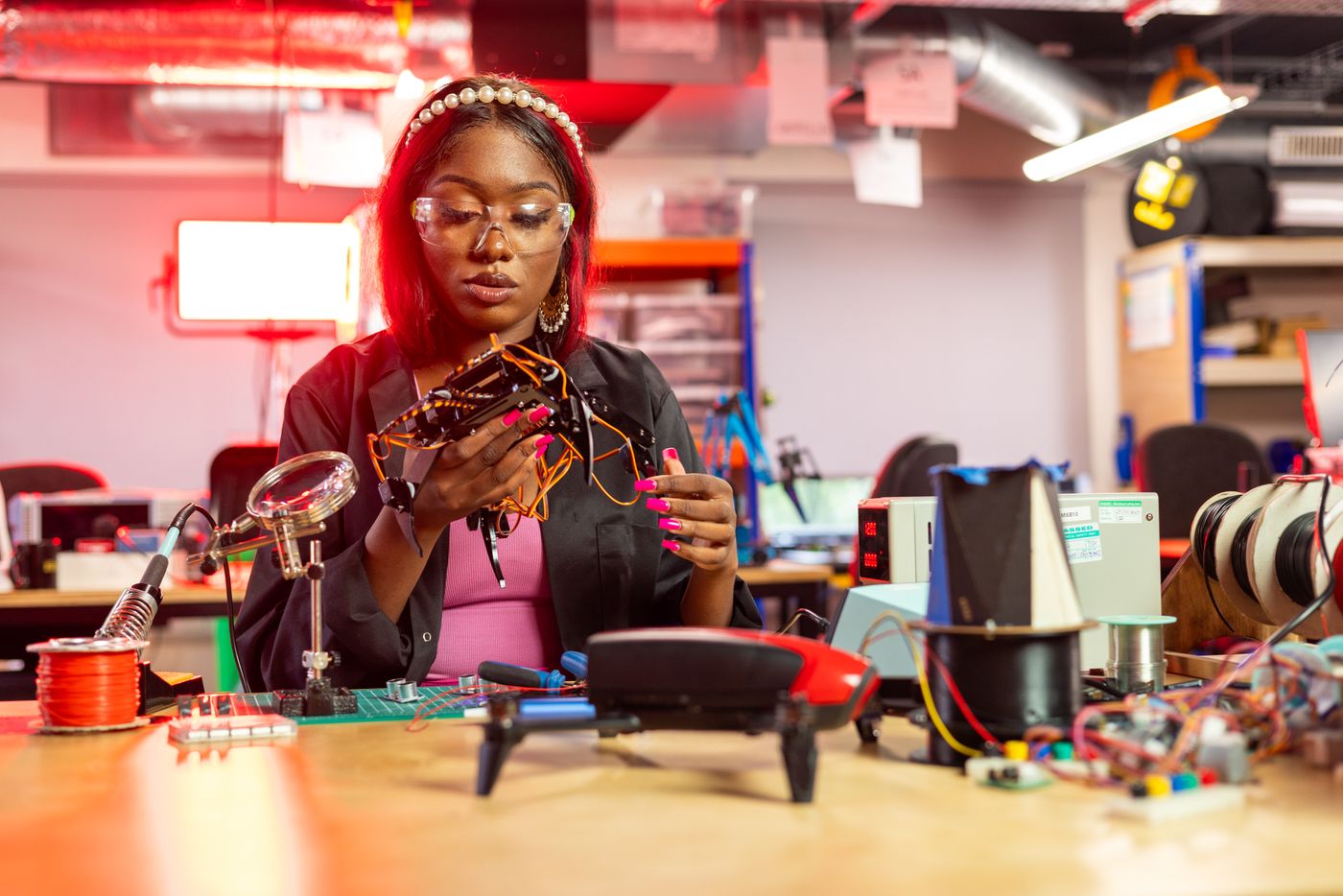 Engineer assembling and testing a security drone on a lab workbench